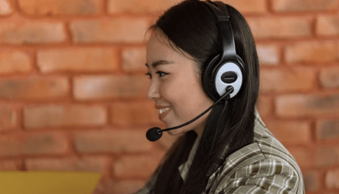 Online Chat Agent wearing a headset while providing online support in a remote customer service job
